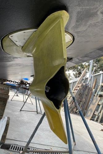 Slide: The Image of 2020 Tiara Yachts 39 Coupe hull detail in dry dock, showcasing underwater components. - 13