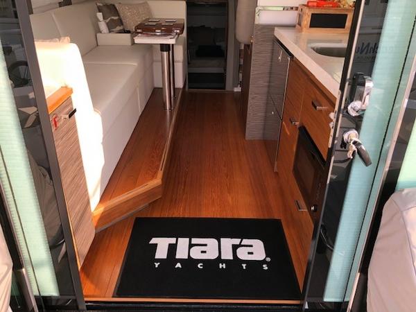 Slide: The Image of Interior view of 2020 Tiara Yachts 39 Coupe, featuring elegant wood flooring and modern furnishings. - 17