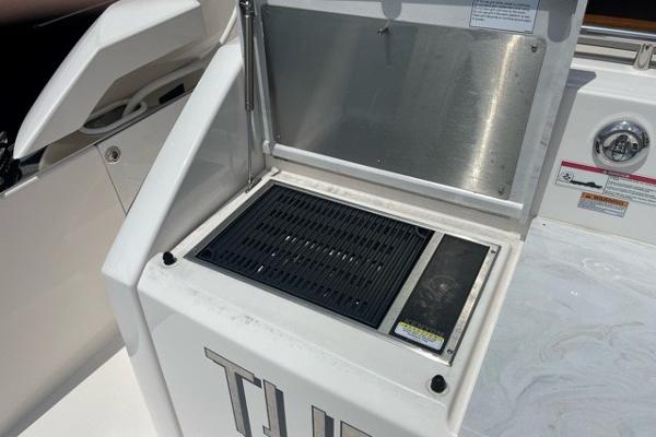 Slide: The Image of Outdoor grill on 2020 Tiara Yachts 39 Coupe, open lid, stainless steel interior. - 20