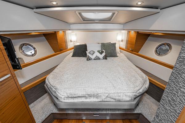 Slide: The Image of Luxurious cabin interior of 2020 Tiara Yachts 39 Coupe with modern bedding and lighting. - 30