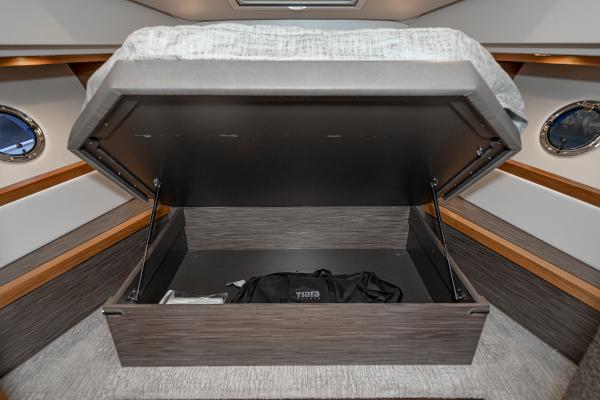 Slide: The Image of Under-bed storage in 2020 Tiara Yachts 39 Coupe, featuring a spacious compartment with a bag. - 31