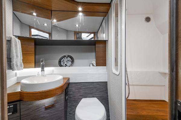 Slide: The Image of Luxurious bathroom interior of 2020 Tiara Yachts 39 Coupe with modern fixtures and wood accents. - 34