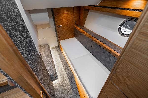 Slide: The Image of 2020 Tiara Yachts 39 Coupe interior cabin with modern wood finish and cozy bedding. - 38
