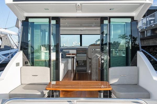 Slide: The Image of 2020 Tiara Yachts 39 Coupe interior with modern seating and wooden table. - 4