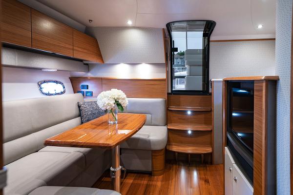 Slide: The Image of Manufacturer Provided Image: 2022 Tiara Yachts 39 Open interior with modern seating, wooden table, and stairs. - 7