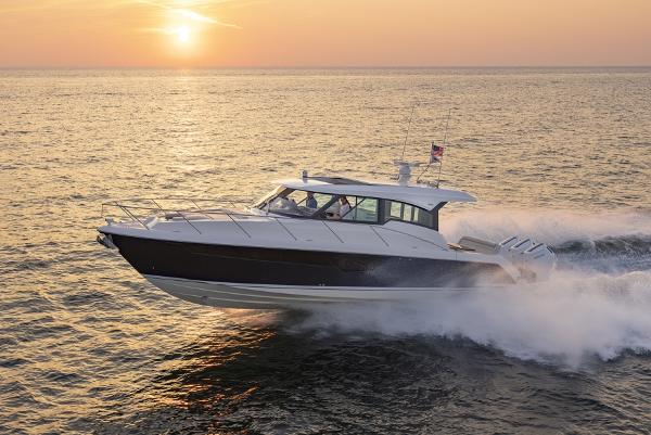 Slide: The Image of 2025 Tiara Yachts 48LE cruising at sunset on open water. - 0