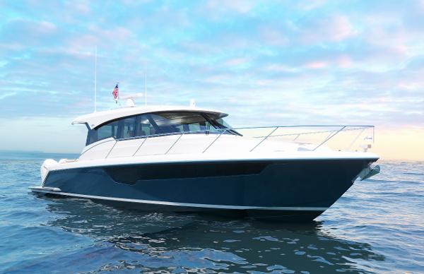 Slide: The Image of 2025 Tiara Yachts 48LE cruising on open water under a vibrant sky. - 4