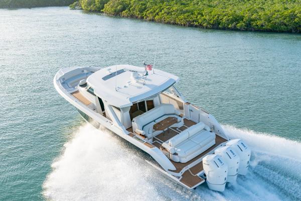 Slide: The Image of 2025 Tiara Yachts 48 LS cruising on a scenic waterway. - 1