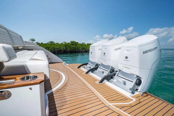 Slide: The Image of 2025 Tiara Yachts 48 LS with Mercury engines on teak deck, sunny day. - 5