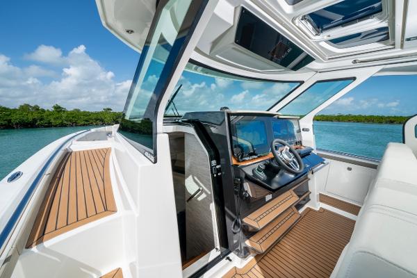 Slide: The Image of 2025 Tiara Yachts 48 LS helm with luxurious interior and scenic ocean view. - 9