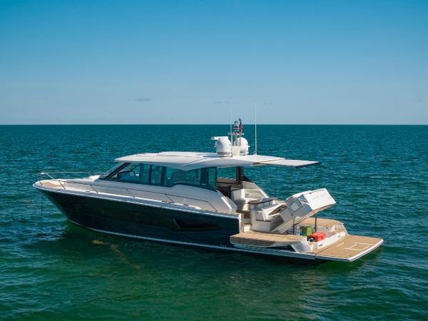 Slide: The Image of 2025 Tiara Yachts EX 60 luxury yacht cruising on open sea. - 0