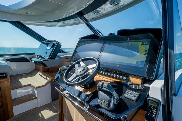 Slide: The Image of 2025 Tiara Yachts EX 60 helm with advanced navigation technology and luxurious interior. - 31