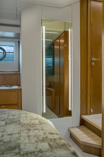 Slide: The Image of Luxurious interior of 2025 Tiara Yachts EX 60 with modern wood finishes and elegant design. - 36