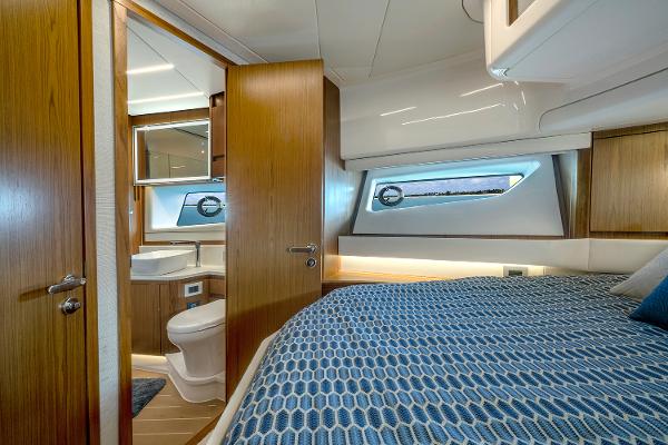 Slide: The Image of Luxurious 2025 Tiara Yachts EX 60 cabin interior with modern design and cozy bedding. - 46
