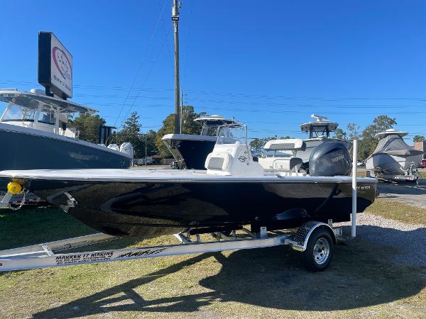 Slide: The Image of 2024 Tidewater 1910 Bay Max boat on trailer, displayed outdoors under clear blue sky. - 0