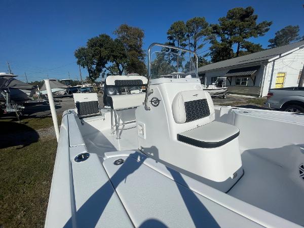 Slide: The Image of 2024 Tidewater 1910 Bay Max boat with seating, console, and clear sky background. - 11