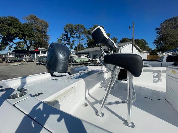 Slide: The Image of 2024 Tidewater 1910 Bay Max boat with seating and motor, parked outdoors. - 5