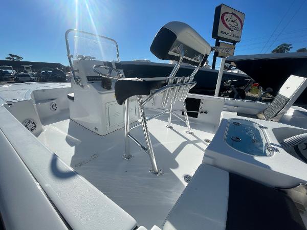Slide: The Image of 2024 Tidewater 1910 Bay Max boat interior with seating and console under bright sunlight. - 7