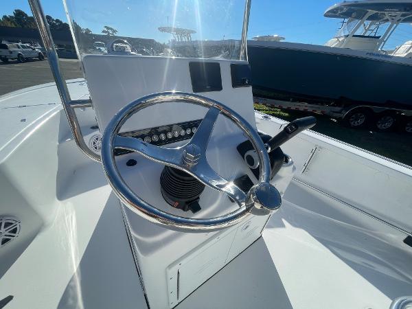 Slide: The Image of 2024 Tidewater 1910 Bay Max boat steering console with chrome wheel and controls. - 8
