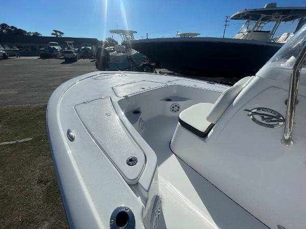 Slide: The Image of 2024 Tidewater 1910 Bay Max boat, white interior, docked under clear blue sky. - 9