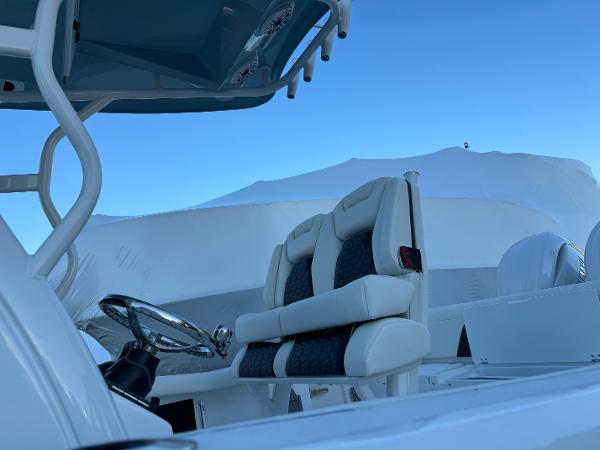 Slide: The Image of 2024 Tidewater 256 LXF boat interior with dual seats and steering wheel. - 1