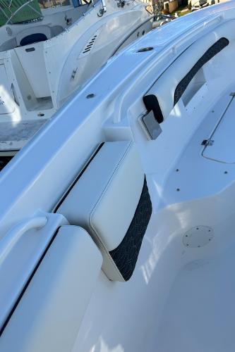Slide: The Image of 2024 Tidewater 256 LXF boat interior with white seating and black accents. - 11