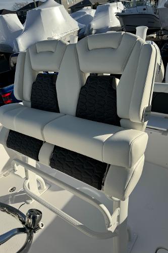 Slide: The Image of 2024 Tidewater 256 LXF boat with dual cushioned seats and black accents. - 14