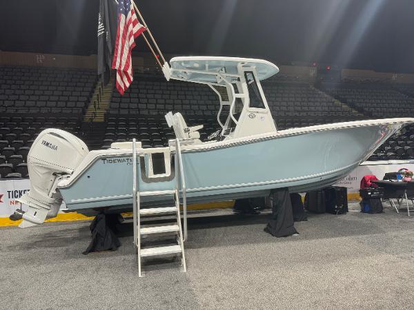 Slide: The Image of 2024 Tidewater 256 LXF boat on display with Yamaha engine and American flag. - 18