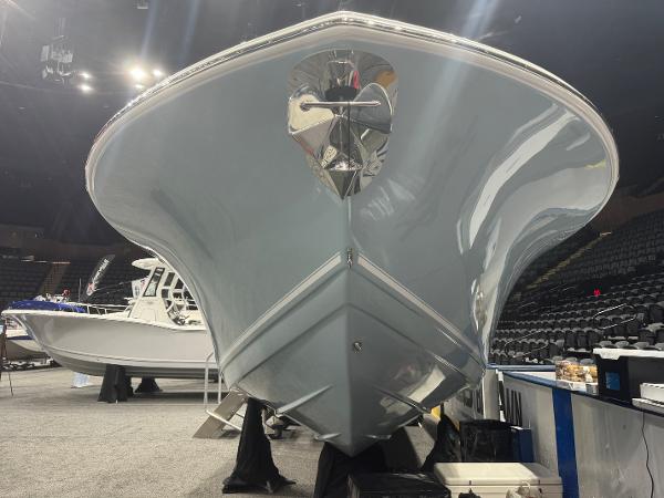 Slide: The Image of 2024 Tidewater 256 LXF boat showcased at an indoor event. - 19