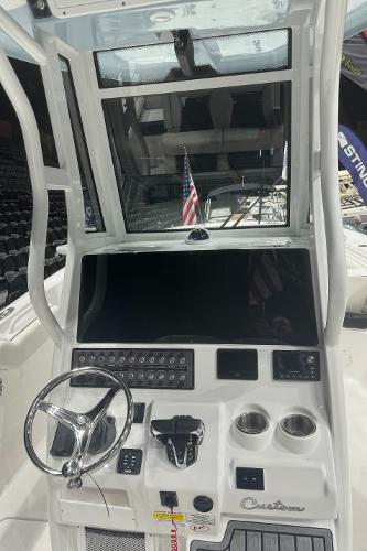 Slide: The Image of 2024 Tidewater 256 LXF boat console with steering wheel and control panel. - 26