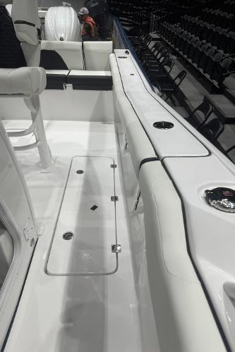 Slide: The Image of 2024 Tidewater 256 LXF boat interior with white seating and storage compartments. - 31