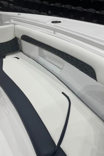 Slide: The Image of 2024 Tidewater 256 LXF boat interior seating with white and black upholstery. - 32