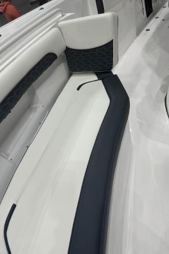 Slide: The Image of 2024 Tidewater 256 LXF boat interior seating with white and black upholstery. - 34