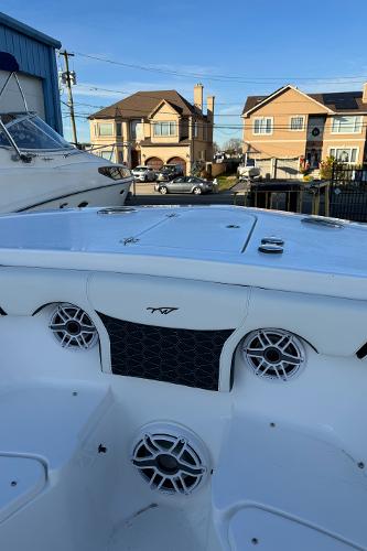 Slide: The Image of 2024 Tidewater 256 LXF boat interior with speakers and storage compartments. - 8