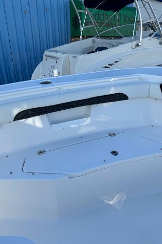 Slide: The Image of 2024 Tidewater 256 LXF boat interior with storage compartments and seating. - 9