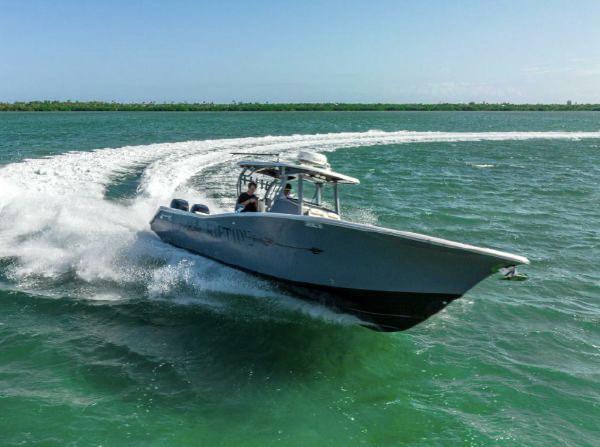 Slide: The Image of 2020 Tidewater 320 CC Adventure boat cruising swiftly on open water. - 1