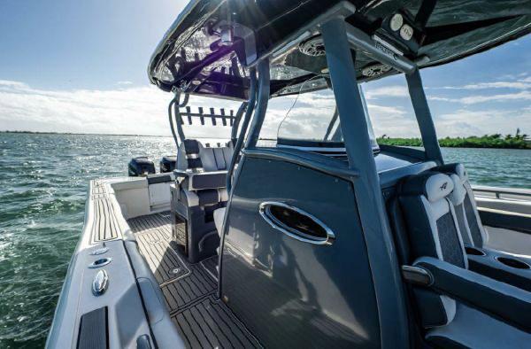 Slide: The Image of 2020 Tidewater 320 CC Adventure boat on open water, showcasing sleek design and spacious deck. - 11