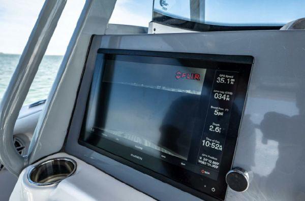 Slide: The Image of Tidewater 320 CC Adventure 2020 boat dashboard with navigation display and controls. - 16
