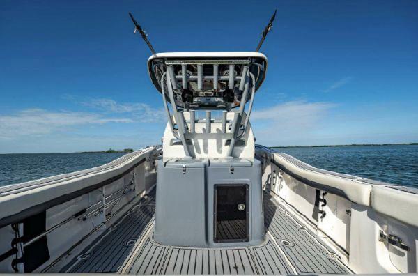 Slide: The Image of 2020 Tidewater 320 CC Adventure boat on open water, showcasing deck and helm. - 20