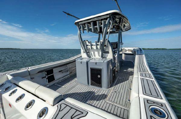Slide: The Image of 2020 Tidewater 320 CC Adventure boat on calm water, showcasing spacious deck and modern design. - 21