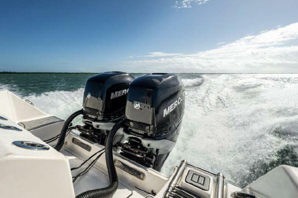Slide: The Image of 2020 Tidewater 320 CC Adventure boat with dual Mercury engines cruising on open water. - 22