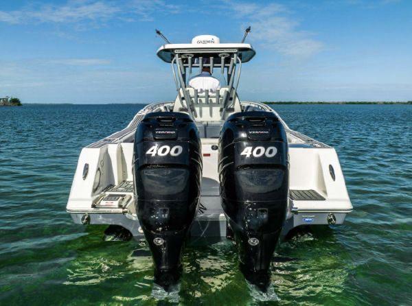 Slide: The Image of 2020 Tidewater 320 CC Adventure boat with twin 400 horsepower engines on open water. - 24