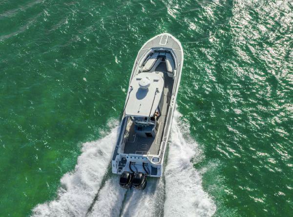 Slide: The Image of Aerial view of 2020 Tidewater 320 CC Adventure boat cruising on green water. - 27