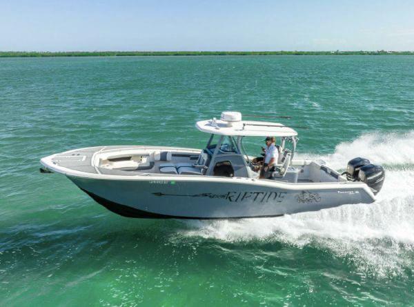Slide: The Image of 2020 Tidewater 320 CC Adventure boat cruising on open water. - 28