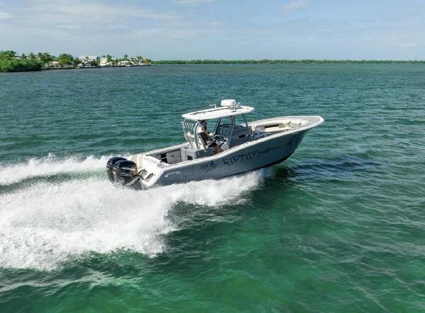 Slide: The Image of 2020 Tidewater 320 CC Adventure boat cruising on open water. - 29