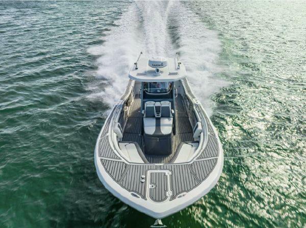 Slide: The Image of 2020 Tidewater 320 CC Adventure boat cruising on open water, aerial view. - 3