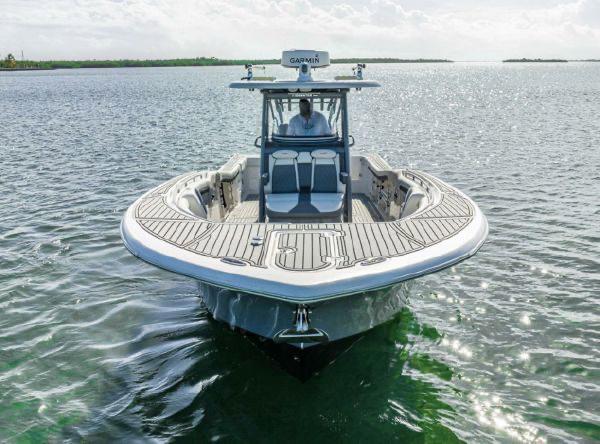 Slide: The Image of 2020 Tidewater 320 CC Adventure boat on calm water, front view. - 5