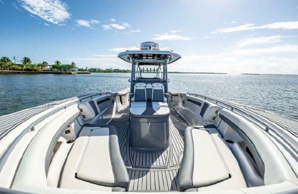 Slide: The Image of 2020 Tidewater 320 CC Adventure boat on calm water, featuring spacious seating and sleek design. - 6