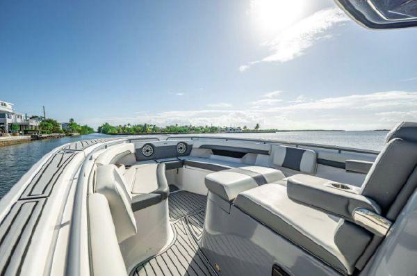 Slide: The Image of 2020 Tidewater 320 CC Adventure boat interior with seating, under clear blue sky. - 8