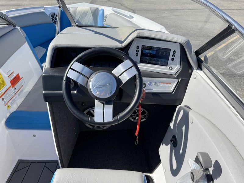 Slide: The Image of 2019 Tigé R21 boat dashboard with steering wheel and control panel. - 10